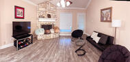 Fully Furnished Living Room with Fireplace
