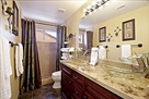Second full bath with dark tile flooring