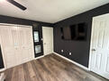 Primary bedroom has 55" mounted TV.