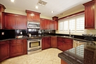 Cherry Wood Cabinetry and Stainless Steel App