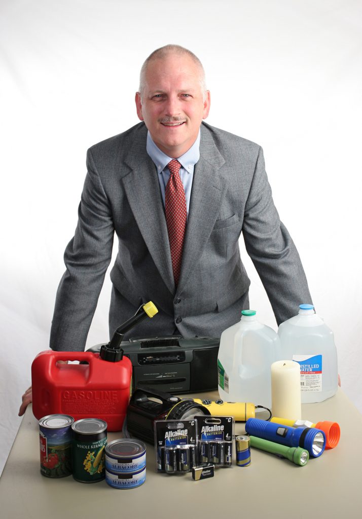 A meteorologist displaying hurricane supplies