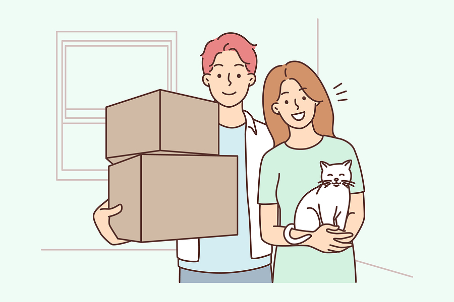 Happy young family with cat holding boxes