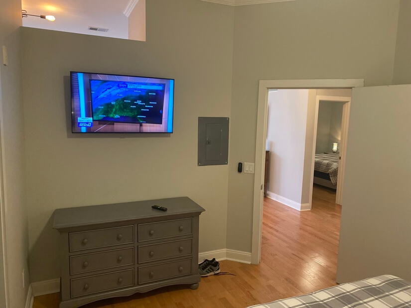 large dresser and flat screen TV in master