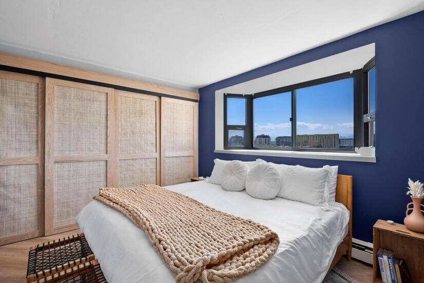 Bedroom with king bed, city & mountain views