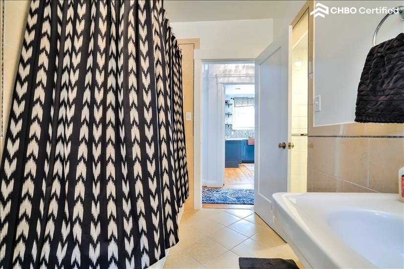 View of downstairs bathroom with 2 showers and 1 bathtub