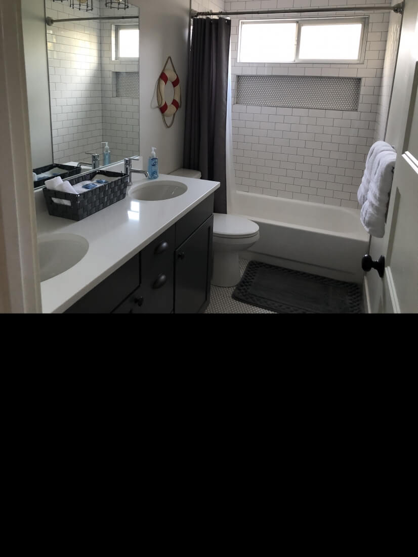 Upstairs hall bathroom with double sinks and