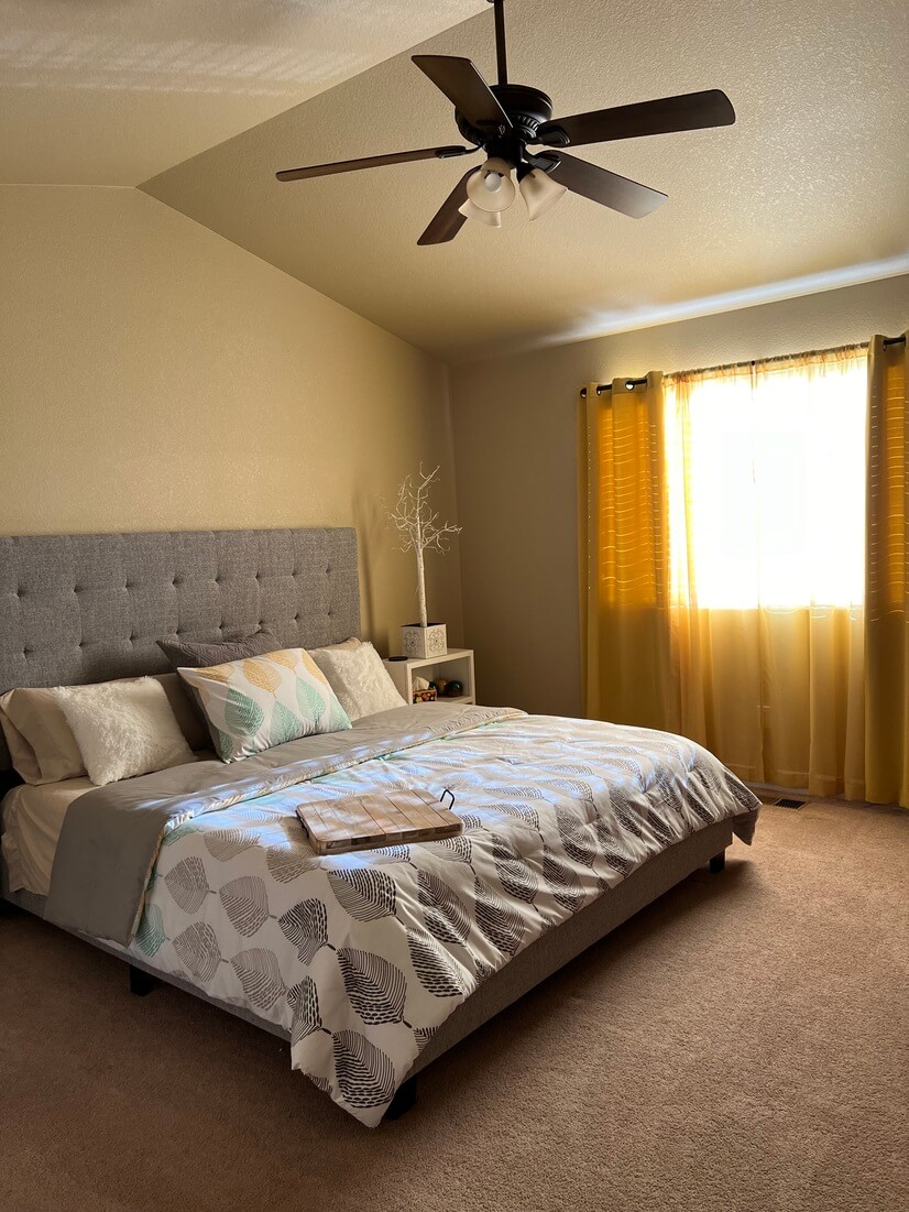 1st bedroom with smart tv and ceiling fan