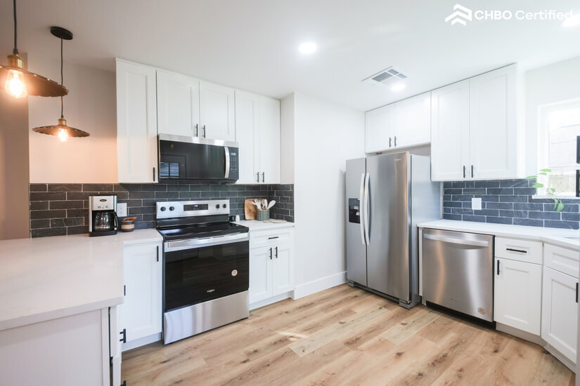 Modern kitchen flows seamlessly into spacious living/dining