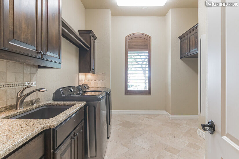 Spacious laundry room with drop down ironing board