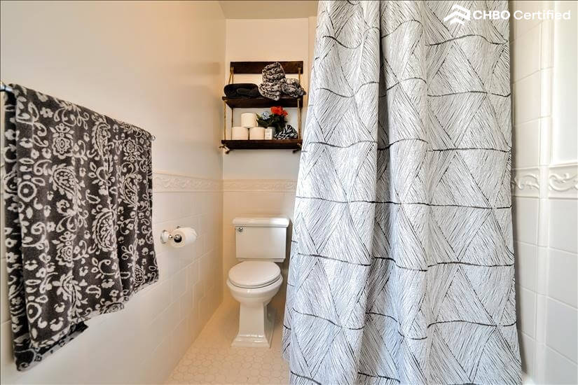 view of toilet and shower upstairs