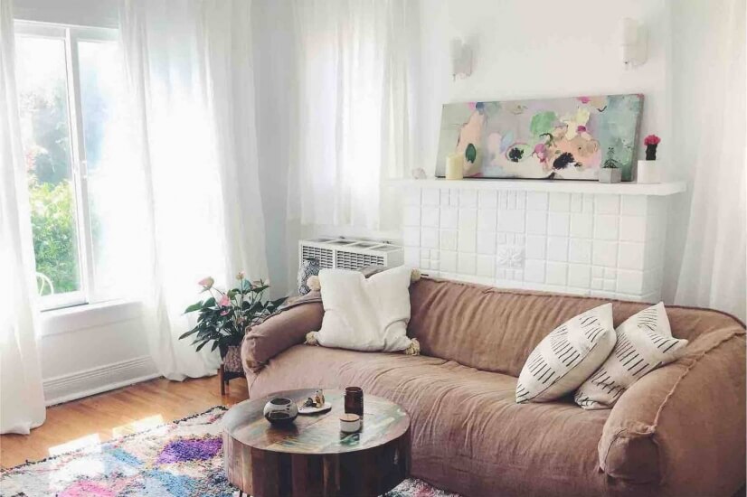 Living room with lots of natural lighting, handmade rugs
