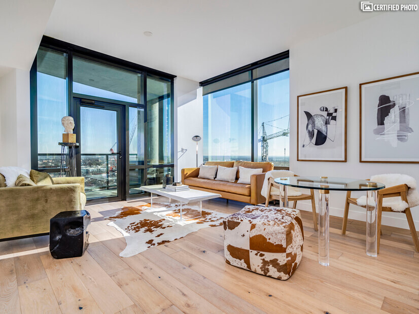 Living room with high floor to ceiling views of Austin