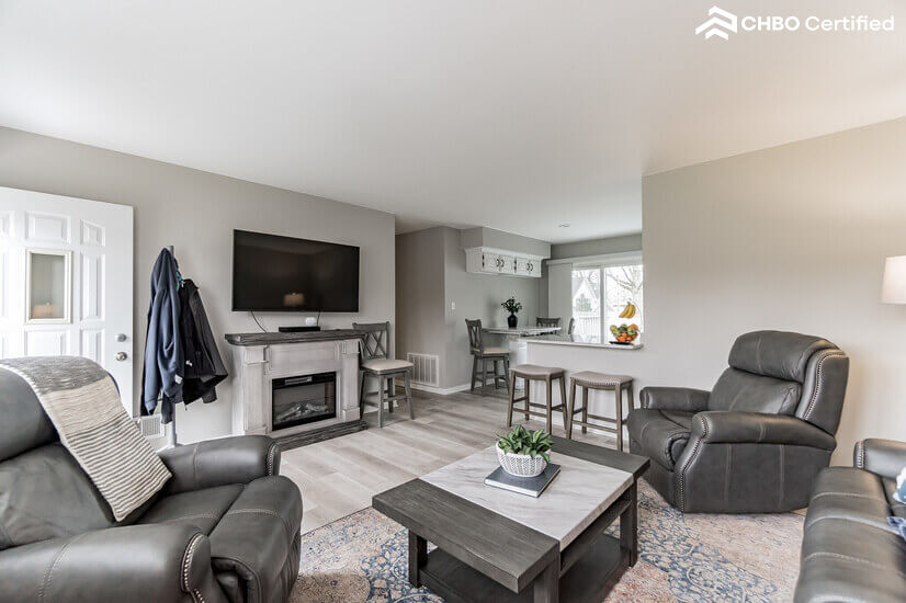 Living room with colorful heated/electric fire place.