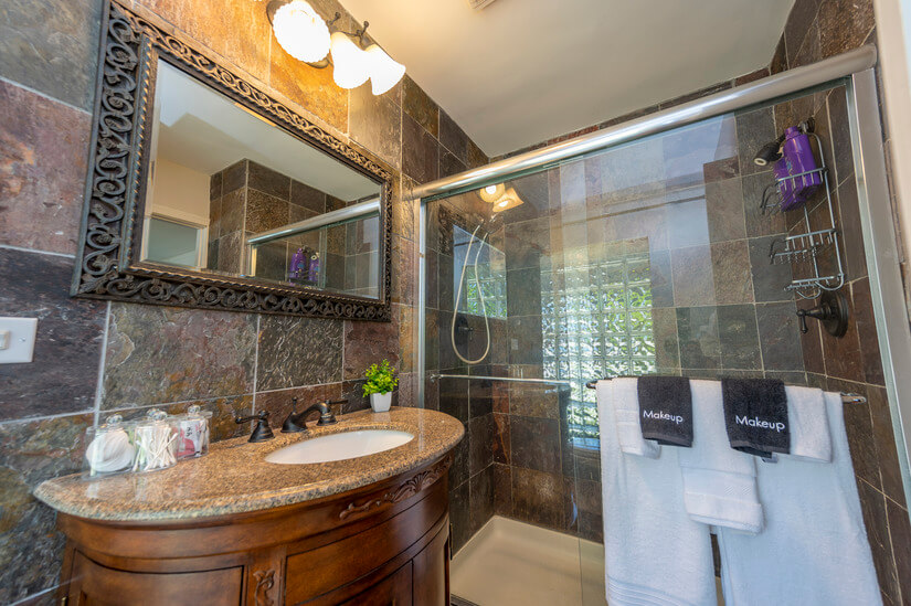 One well-appointed bathroom features a walk-in shower.