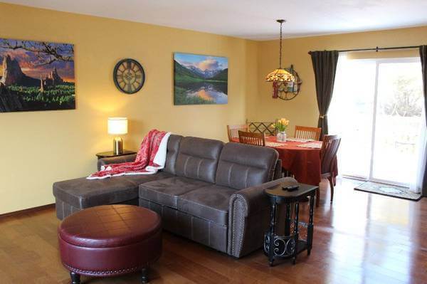 Living room with dining area leading to deck.