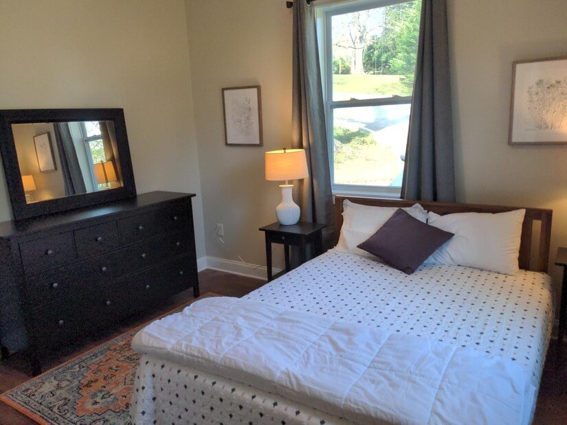 Spare bedroom with queen bed, dresser and closet