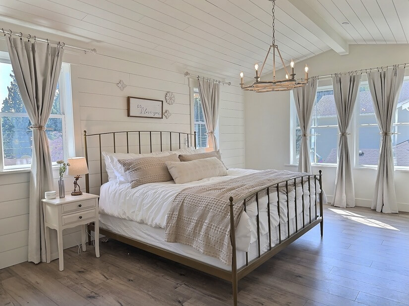 A light-filled bedroom with a comfortable bed