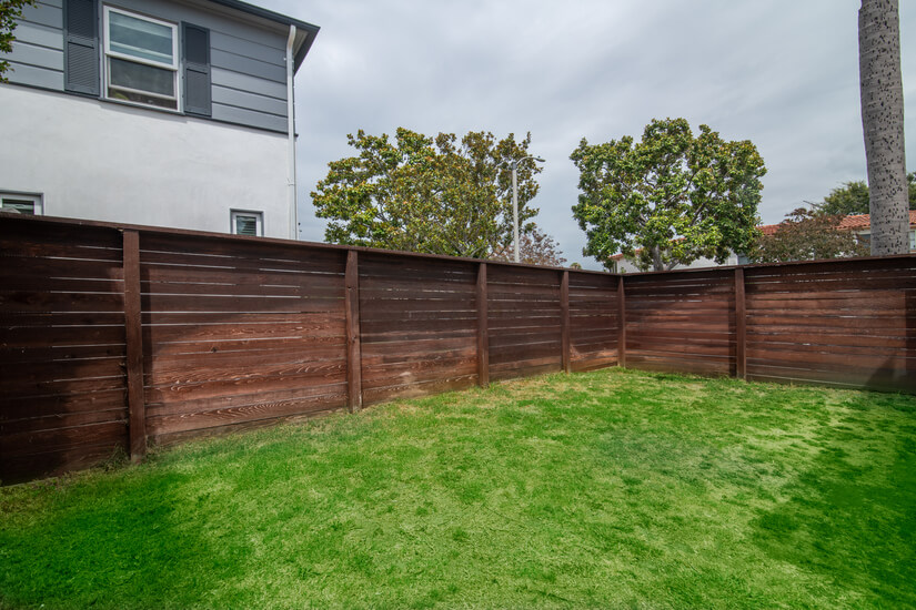 Fully fenced large side yard with grass