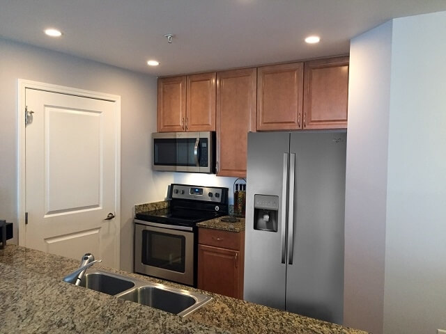 Kitchen with new stainless steel appliances.