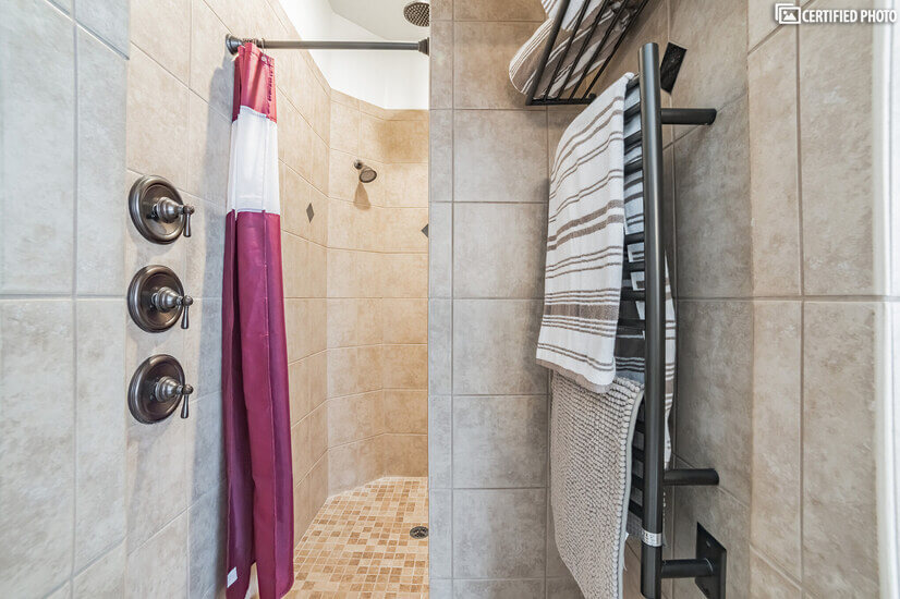 European walk-in shower. Heated towel rack. Dual shower head