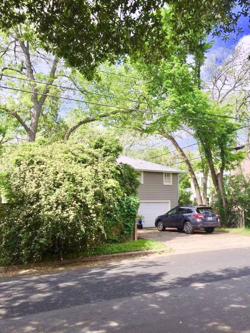 Large oak trees and mature pecan trees surrou