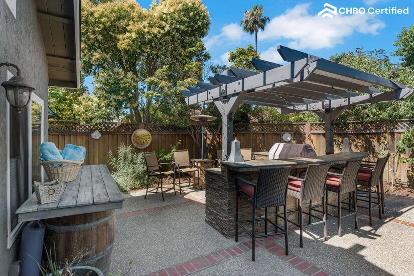 Large outdoor barbque and patio bar seating with mini fridge
