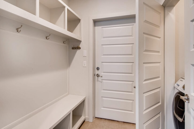 Mudroom complete with coat racks and cubbies