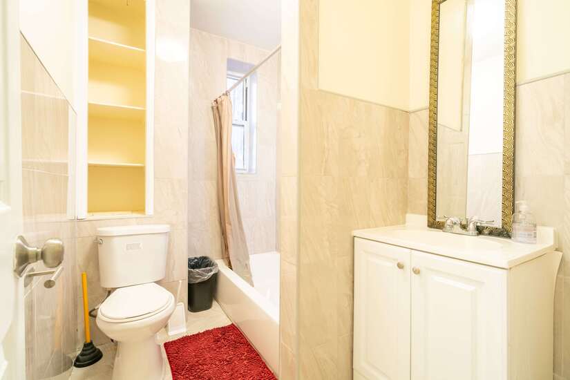 The shared bathroom in this 4-BR apartment.