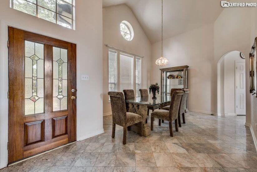 Entryway showing  marble flooring an dining room to the left