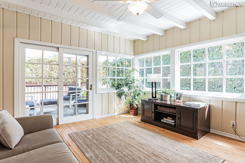 Bright sunroom over looks large private backyard