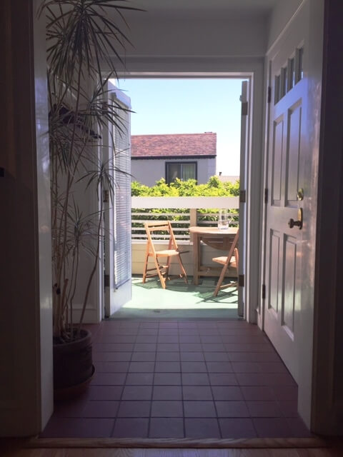 Looking from living room to foyer and deck