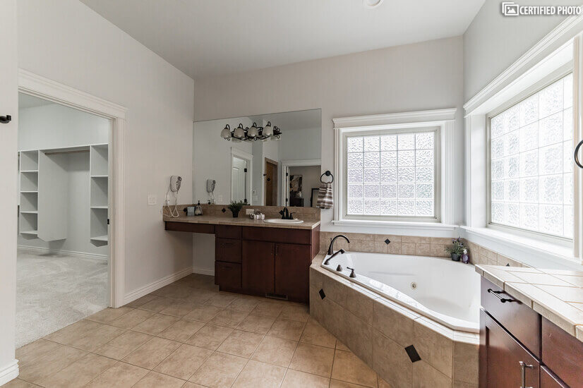Master bath features jetted tub, dual sinks