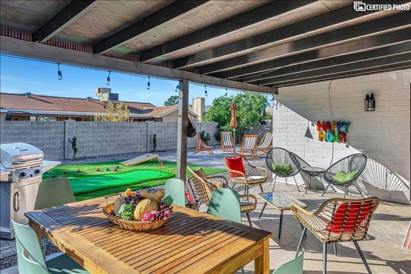 comfortable back patio with smart TV and BBQ