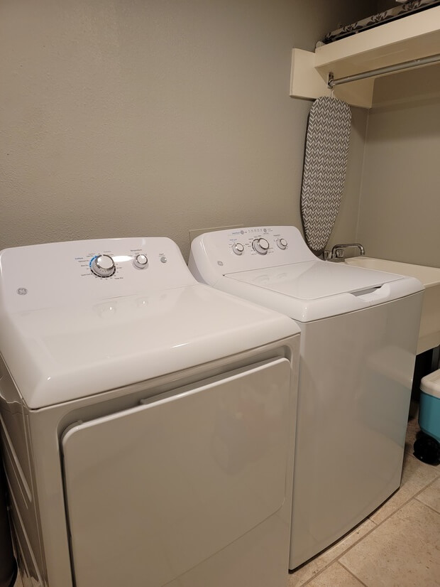 Laundry room with ironing board