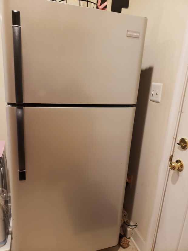 Full fridge and freezer in basemen kitchen