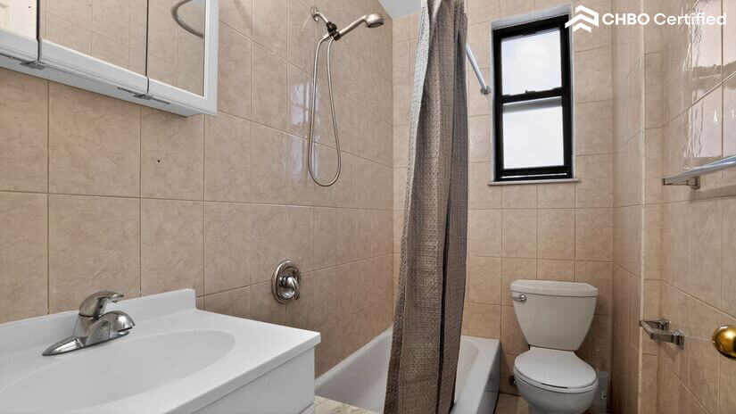 Clean bathroom with bathtub and shower setup