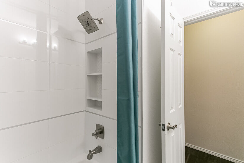 Modern guest bathroom with built-in shower storage