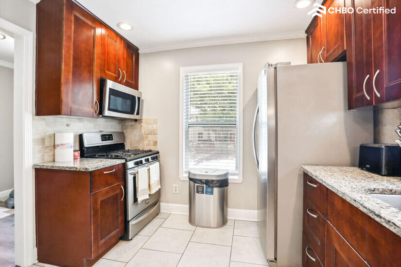 Kitchen featuring stainless microwave and stove