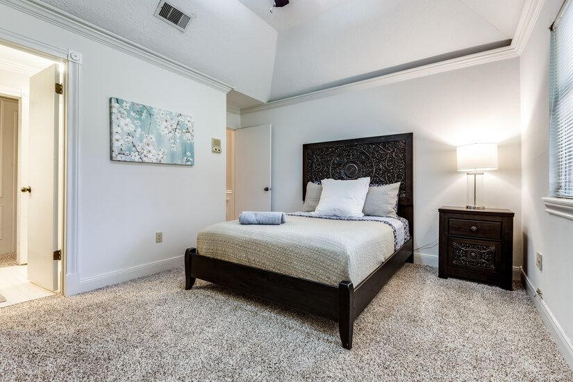 Queen bed with access to shared full bath.