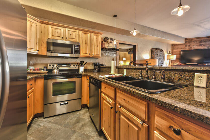 The kitchen is fully equipped, granite counters