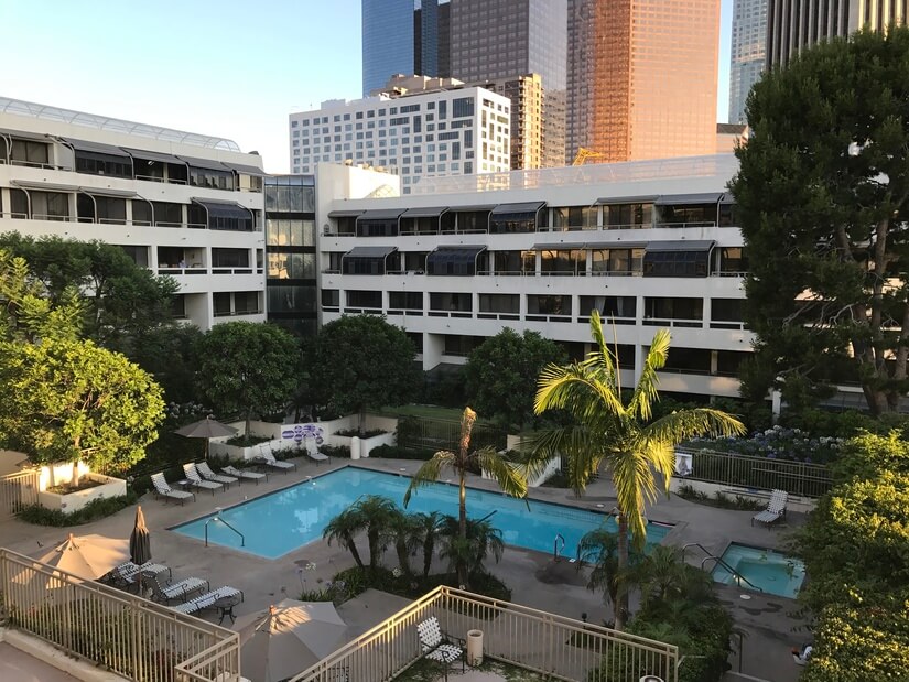 View of pool and garden area from balcony