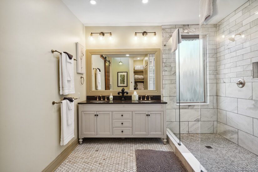 Master bathroom with dual sinks and shower