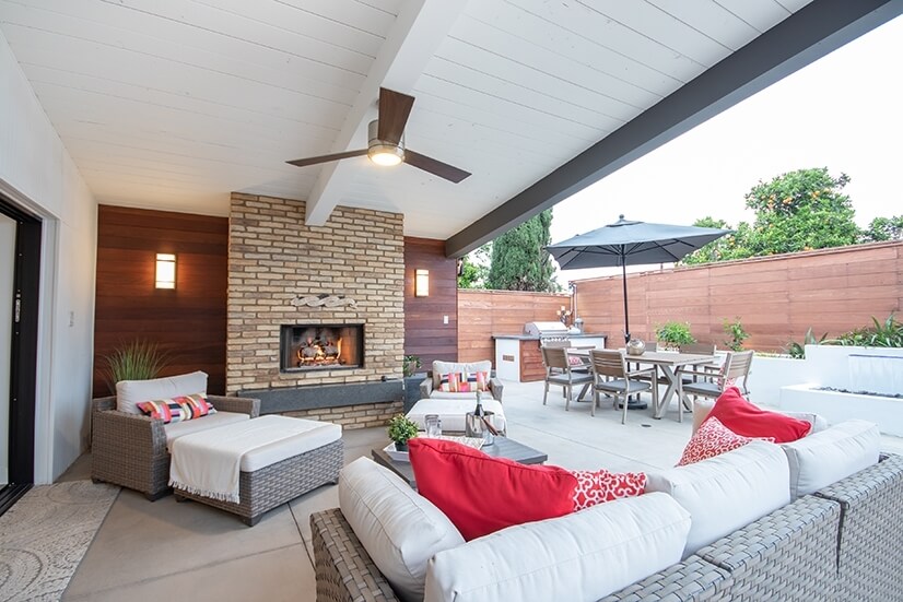 Covered Loggia with fireplace. Outdoor dining table and BBQ