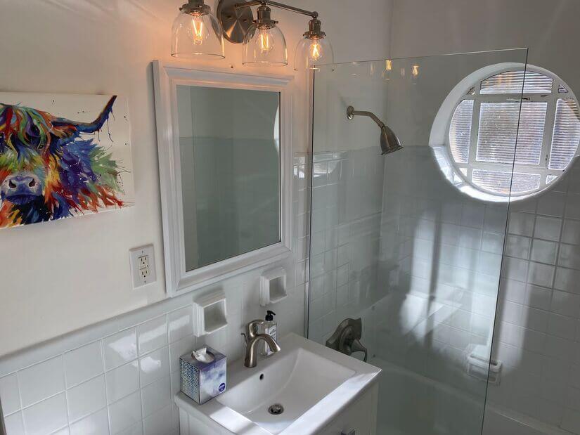 Shared bath w ceramic tub and glass enclosure