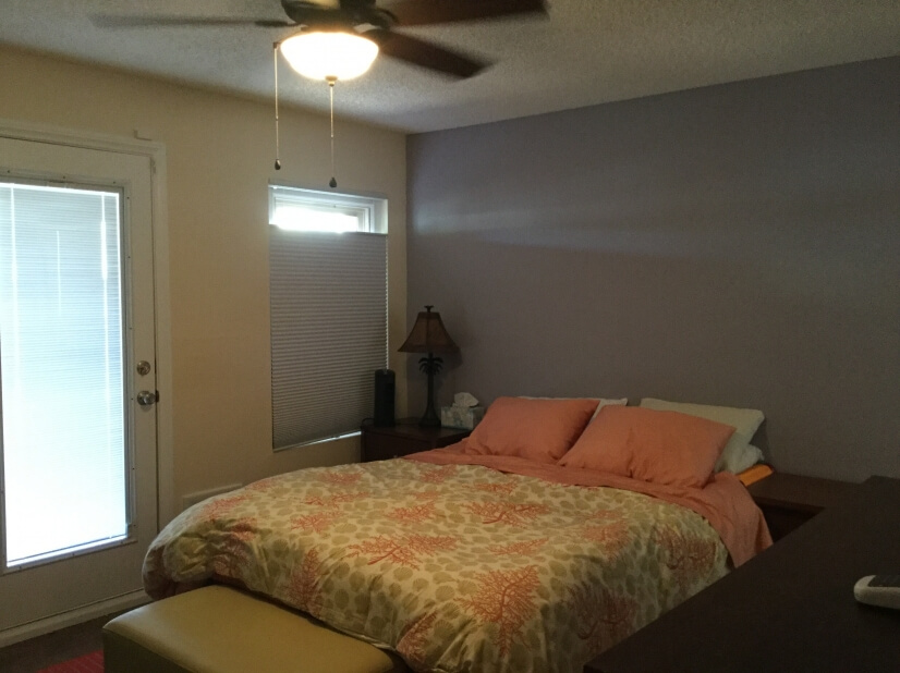 Master bedroom with ceiling fan and access to