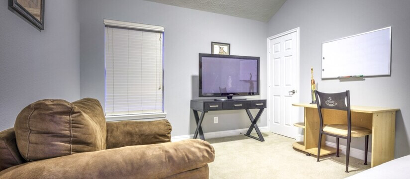 Office and lounge room with tv and desk