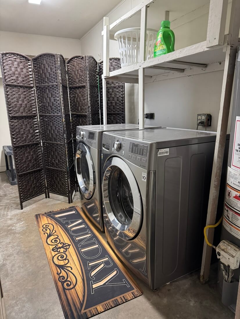 Private laundry room with utility storage