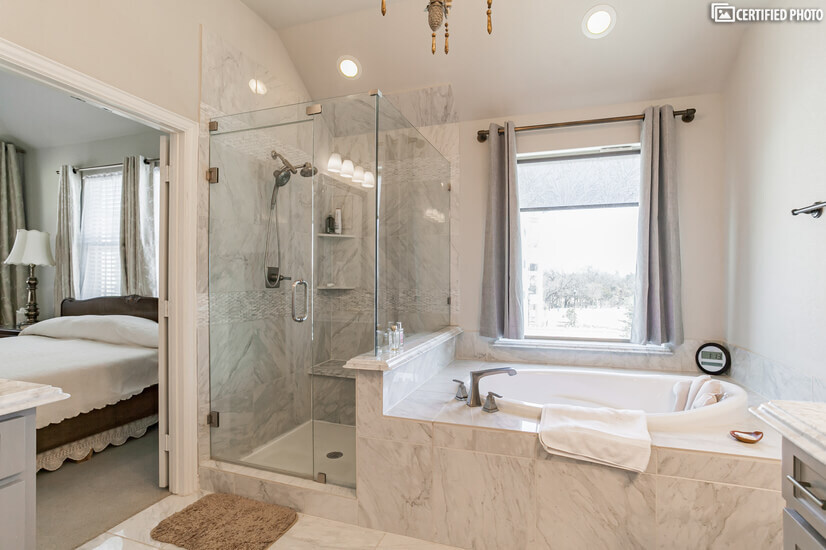 luxurious tub with all marble surroundings