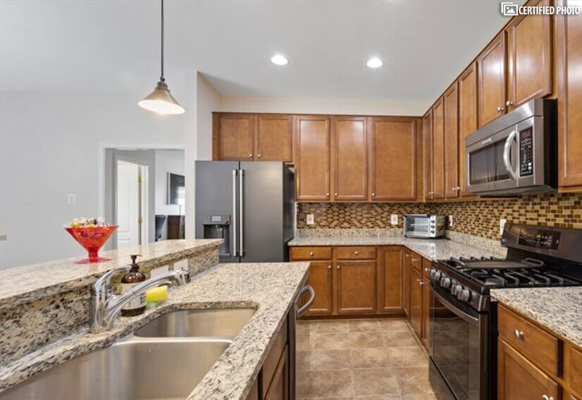 Kitchen with granite countertops and newer appliances.