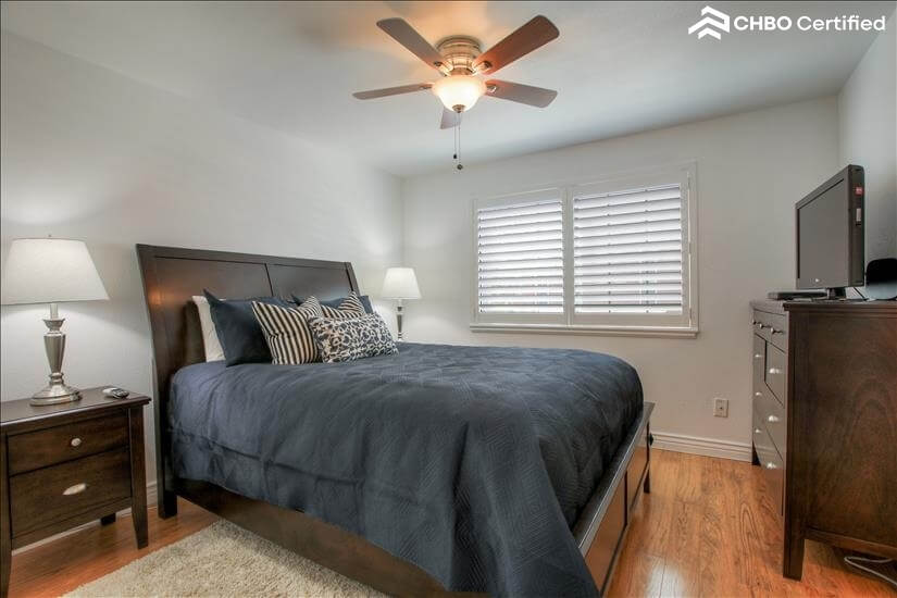 Master bedroom with fan and TV